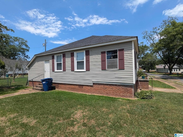 view of side of home with a lawn