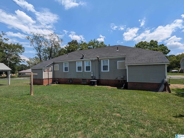 back of house featuring cooling unit and a lawn