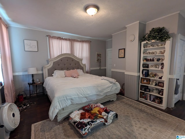 bedroom featuring dark hardwood / wood-style flooring, multiple windows, and ornamental molding