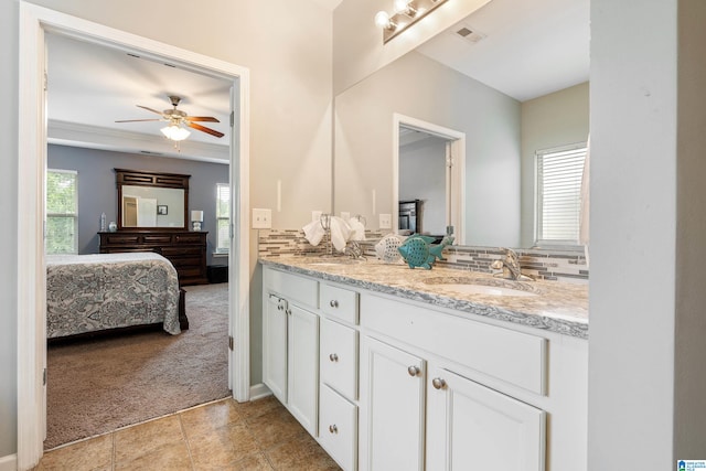 bathroom featuring ceiling fan, tile patterned floors, and double sink vanity