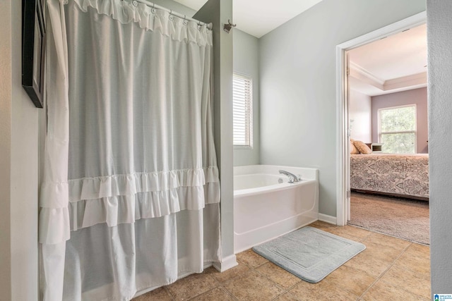 bathroom featuring a bathing tub, crown molding, a tray ceiling, and tile patterned floors