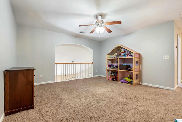 rec room with carpet and ceiling fan