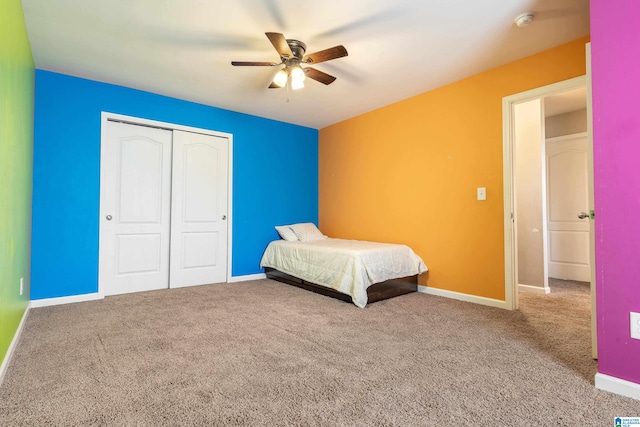 unfurnished bedroom featuring carpet floors, ceiling fan, and a closet