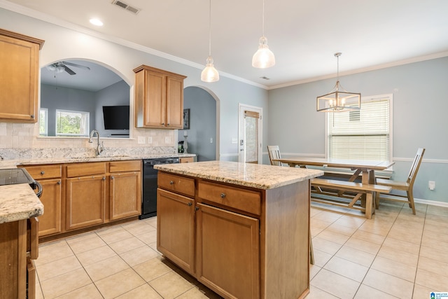 kitchen featuring sink, dishwasher, hanging light fixtures, and backsplash