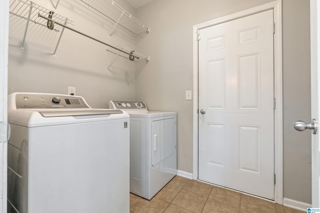 laundry area featuring independent washer and dryer and light tile patterned floors