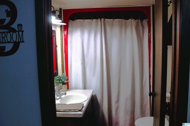 bathroom featuring toilet and vanity