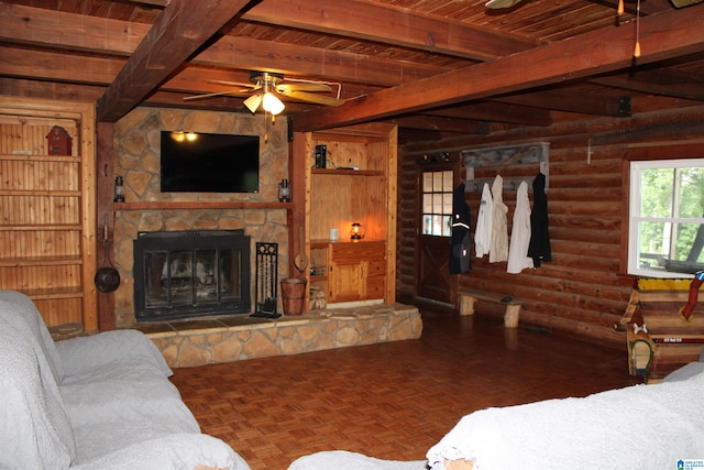 living room featuring beamed ceiling, a fireplace, ceiling fan, and parquet flooring