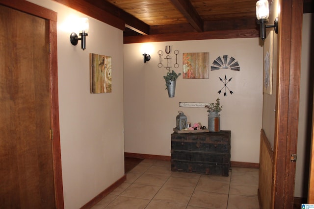 hall with wood ceiling, tile patterned floors, and beam ceiling