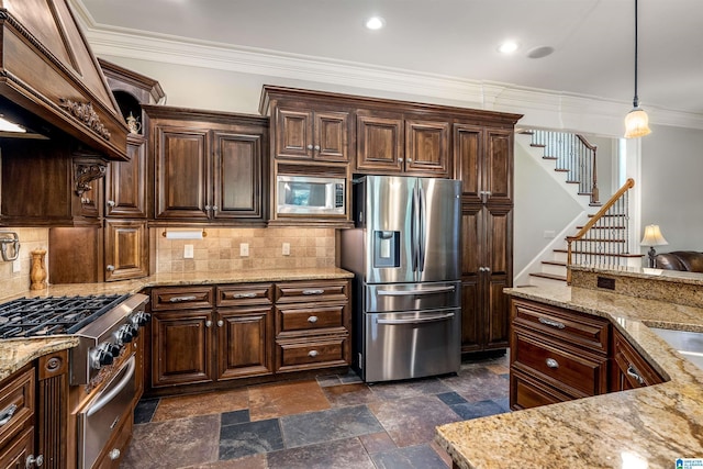 kitchen with pendant lighting, light stone counters, dark brown cabinetry, and appliances with stainless steel finishes