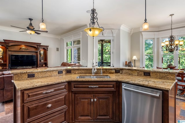 kitchen featuring a kitchen island with sink, sink, decorative light fixtures, and stainless steel dishwasher