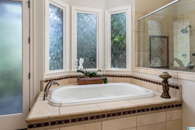 bathroom featuring shower with separate bathtub