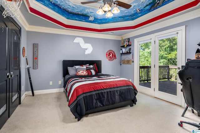 carpeted bedroom featuring ceiling fan, ornamental molding, a raised ceiling, and access to outside