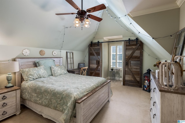 carpeted bedroom with lofted ceiling, ornamental molding, a barn door, and ceiling fan