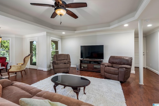 living room featuring ceiling fan, ornamental molding, dark hardwood / wood-style floors, and a healthy amount of sunlight