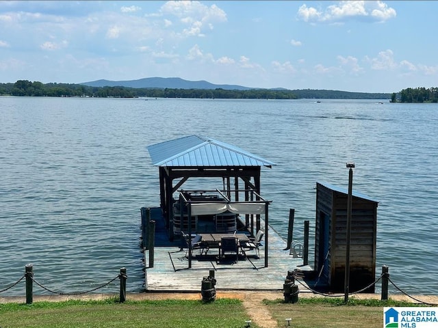 view of dock featuring a water and mountain view