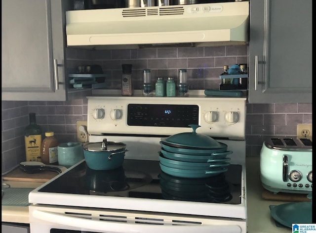 kitchen with gray cabinets, white range with electric stovetop, and decorative backsplash