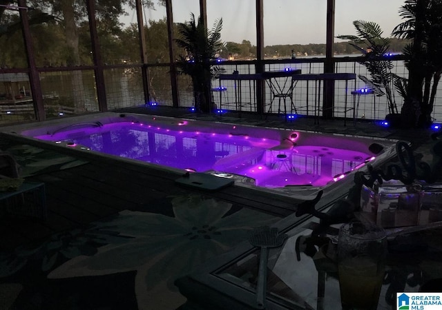 view of pool at dusk