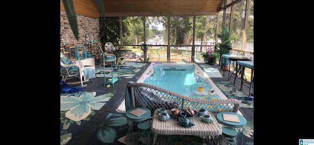 view of swimming pool featuring glass enclosure