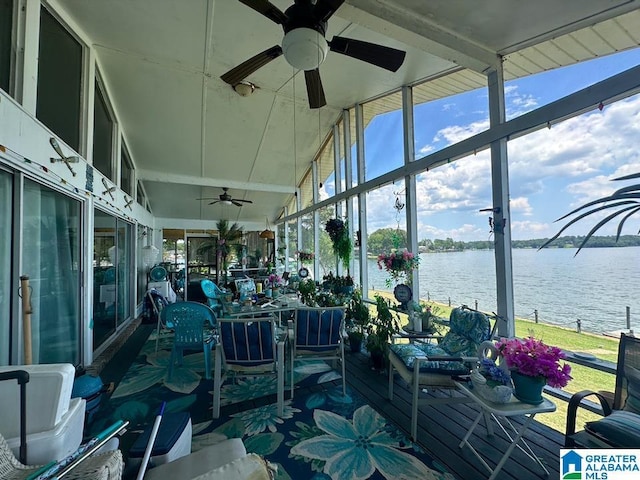 sunroom featuring a water view, lofted ceiling, and ceiling fan