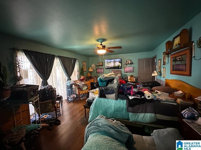 bedroom with ceiling fan and dark hardwood / wood-style flooring