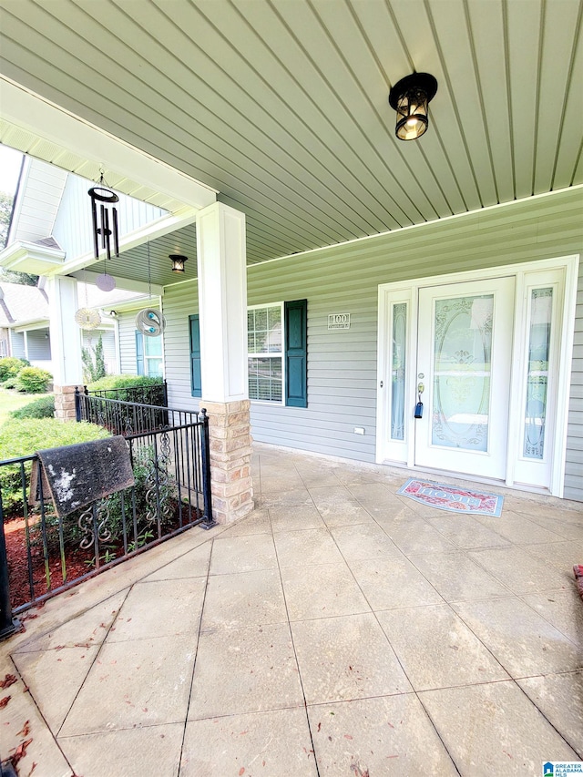 view of exterior entry with covered porch