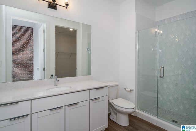 bathroom featuring vanity, toilet, hardwood / wood-style floors, and an enclosed shower