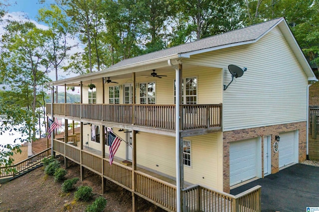 rear view of house featuring ceiling fan, a porch, and a garage