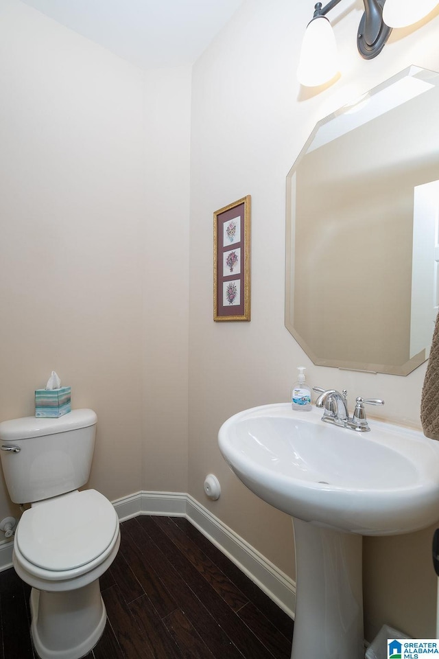 bathroom featuring hardwood / wood-style floors and toilet