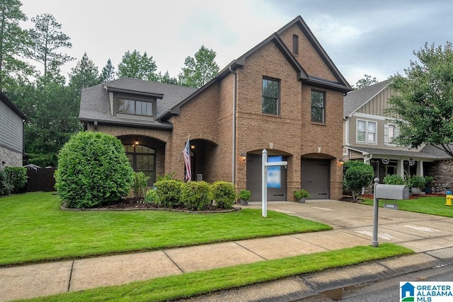 view of front of house featuring a front yard and a garage