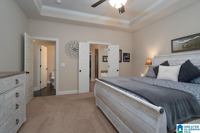 carpeted bedroom with ceiling fan, crown molding, connected bathroom, and a raised ceiling