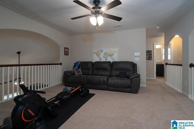 carpeted living room featuring ceiling fan