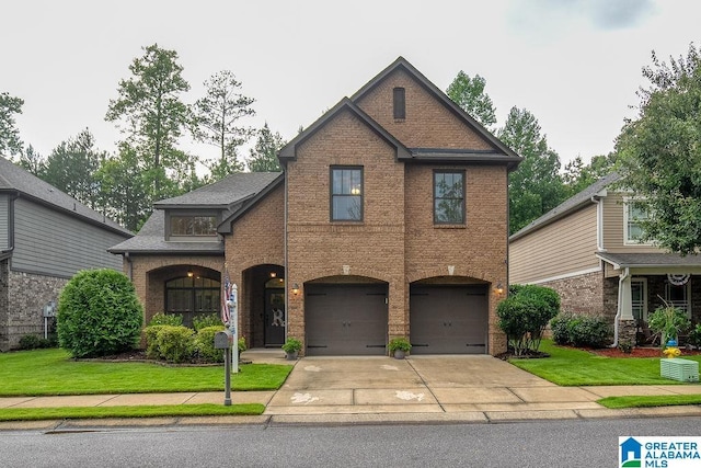 view of front of home with a front lawn and a garage