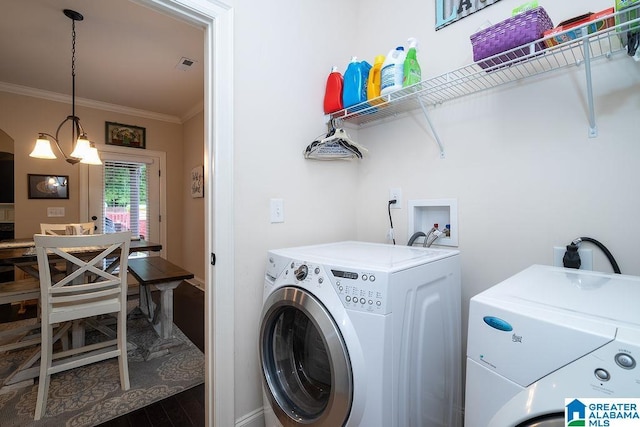 washroom with dark hardwood / wood-style flooring, a chandelier, separate washer and dryer, and crown molding