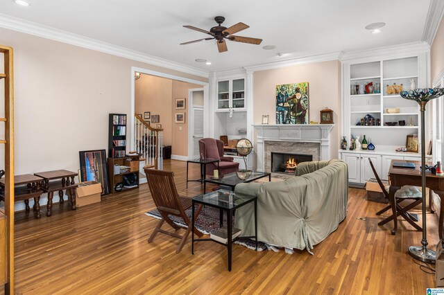 living room featuring crown molding and a premium fireplace