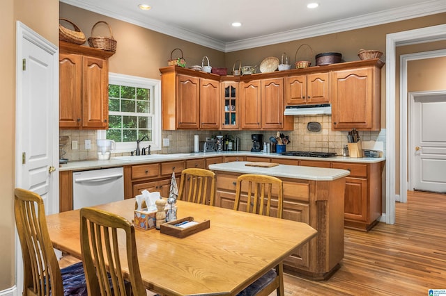 kitchen with gas stovetop, light countertops, dishwasher, and a sink