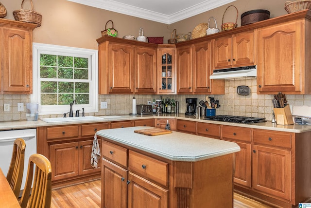 kitchen with ornamental molding, a sink, white dishwasher, black gas stovetop, and under cabinet range hood