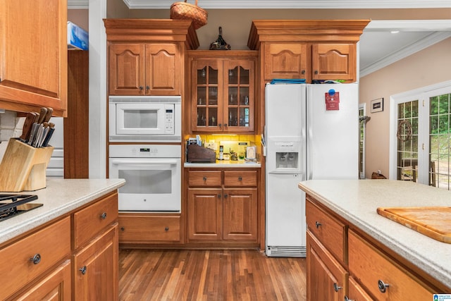 kitchen featuring dark wood-type flooring, white appliances, crown molding, and tasteful backsplash