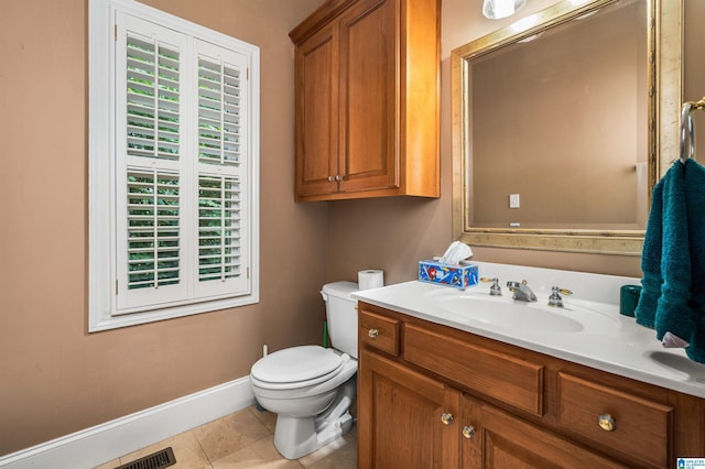 bathroom featuring baseboards, vanity, toilet, and tile patterned floors