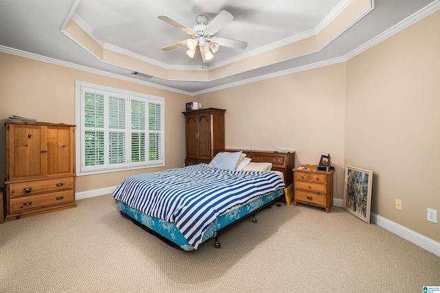 bedroom with light colored carpet, a raised ceiling, visible vents, and baseboards