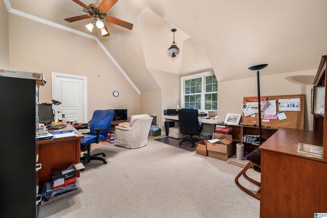 office area with vaulted ceiling, ceiling fan, carpet flooring, and crown molding