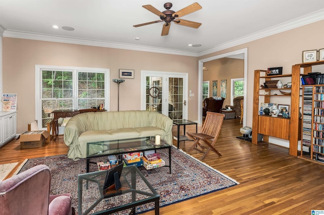 living room with french doors, plenty of natural light, wood finished floors, and crown molding