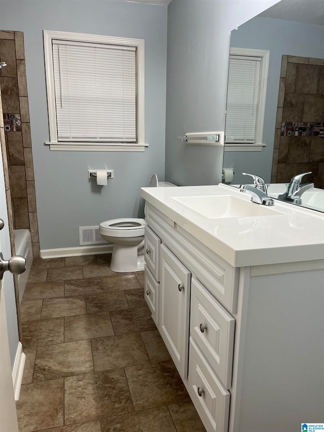 full bathroom with vanity, tile patterned floors, and toilet