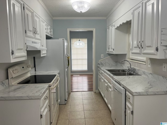 kitchen with white cabinetry, light hardwood / wood-style floors, crown molding, and white appliances