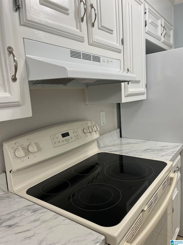 kitchen with white cabinets and white electric range