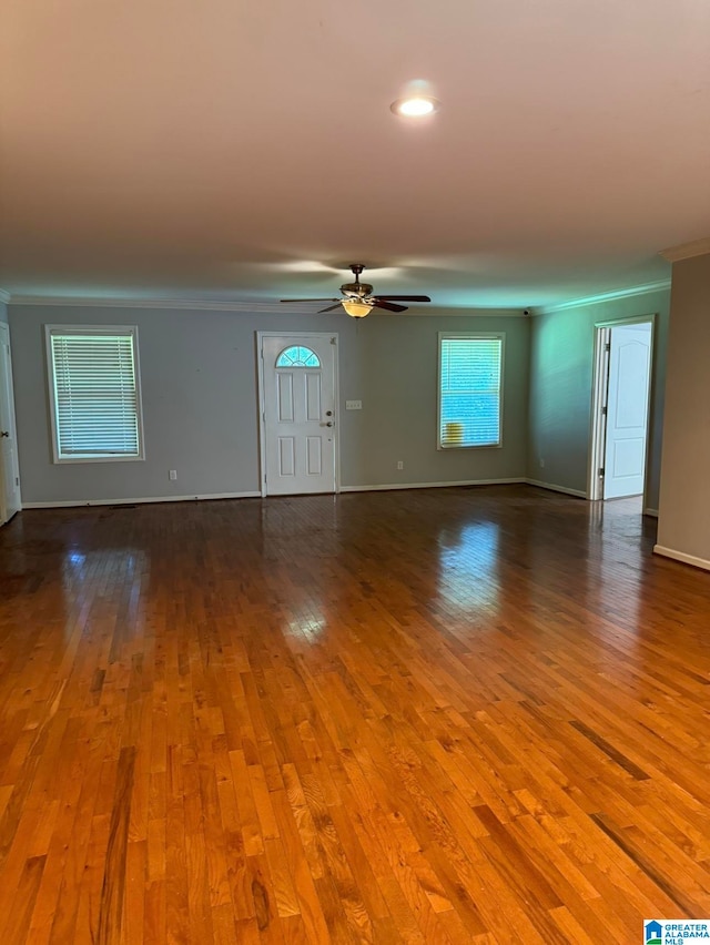 unfurnished room with hardwood / wood-style flooring, ornamental molding, and ceiling fan