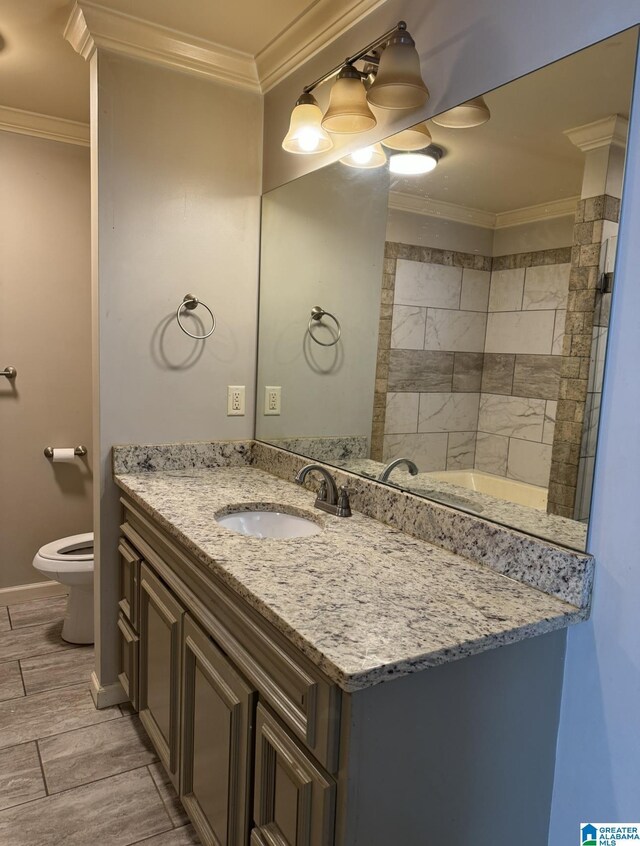 bathroom featuring vanity, crown molding, toilet, and tile patterned flooring