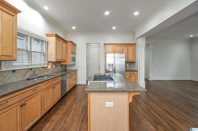 kitchen featuring a kitchen island, tasteful backsplash, dark wood finished floors, a sink, and stainless steel appliances