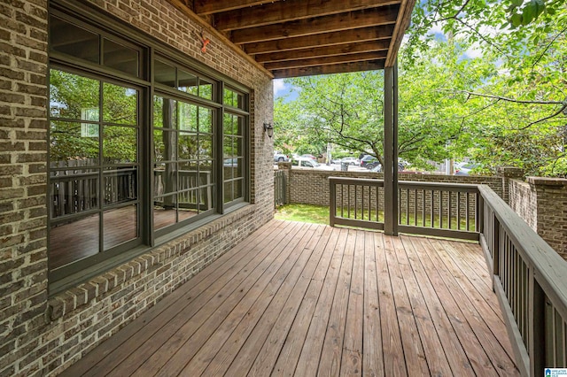 wooden terrace featuring a fenced backyard