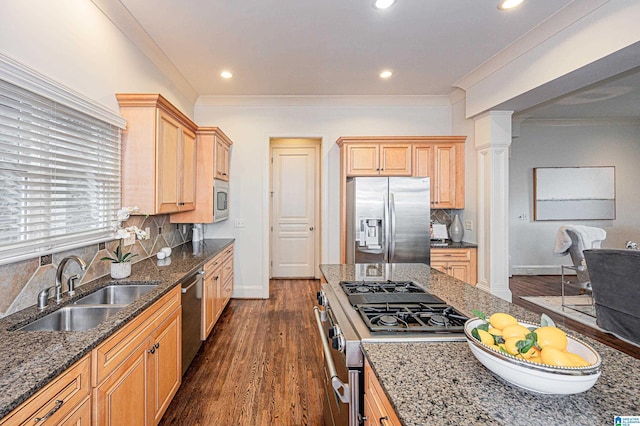 kitchen featuring decorative backsplash, ornate columns, a sink, dark wood finished floors, and appliances with stainless steel finishes