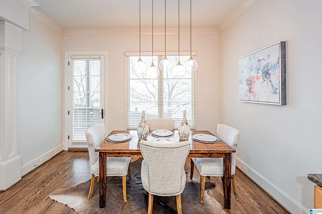 dining area featuring baseboards, ornamental molding, and wood finished floors
